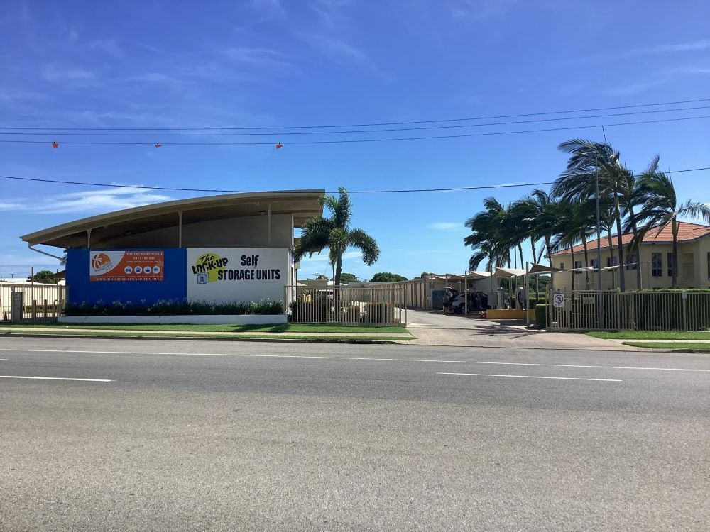 A Building with A Sign on The Side of It Is Next to A Road — Whitsunday Wash In Bowen, QLD