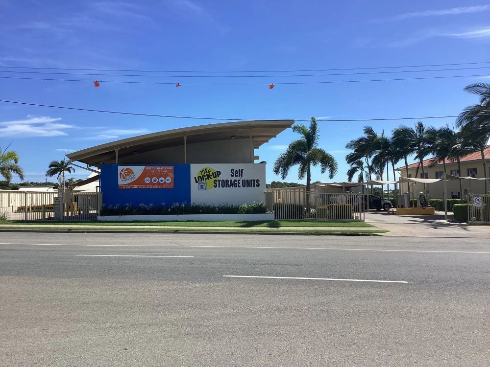 A Large Building Is Sitting on The Side of A Road Next to A Palm Tree — Whitsunday Wash In Bowen, QLD