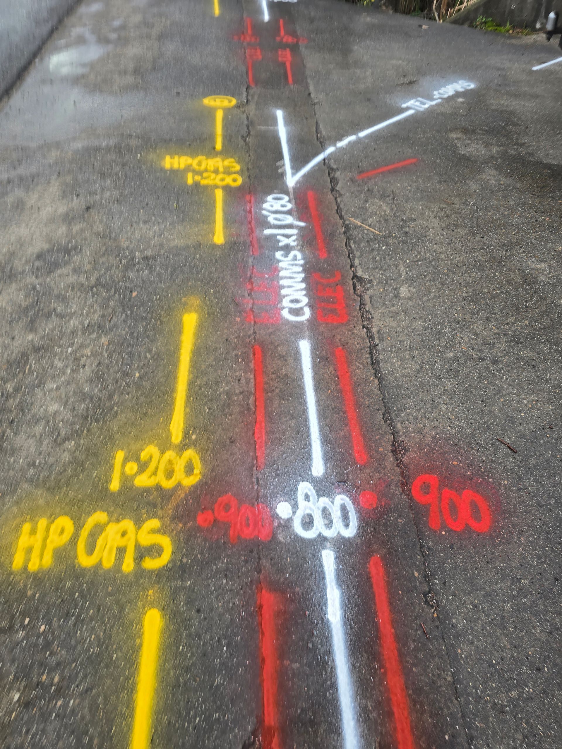 Exposed copper pipe with green end caps in a damaged wall cavity. Electrical outlet above.