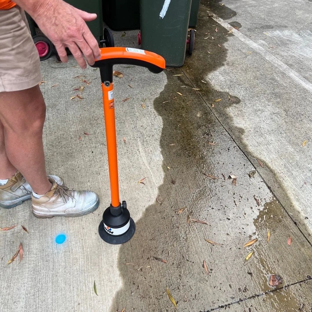 Yellow gas line exposed in a dirt hole.