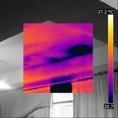 Thermal image of ceiling showing temperature variations, with a color scale and warmer areas in orange/yellow.