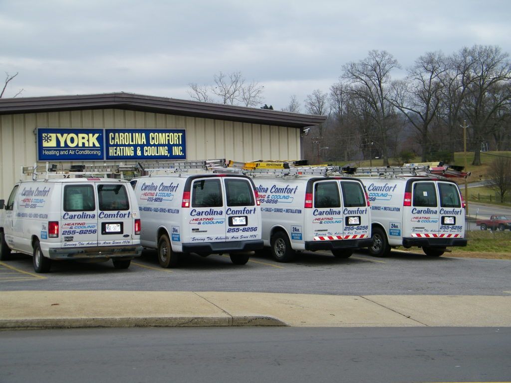 Several vans are parked in front of a building that says york
