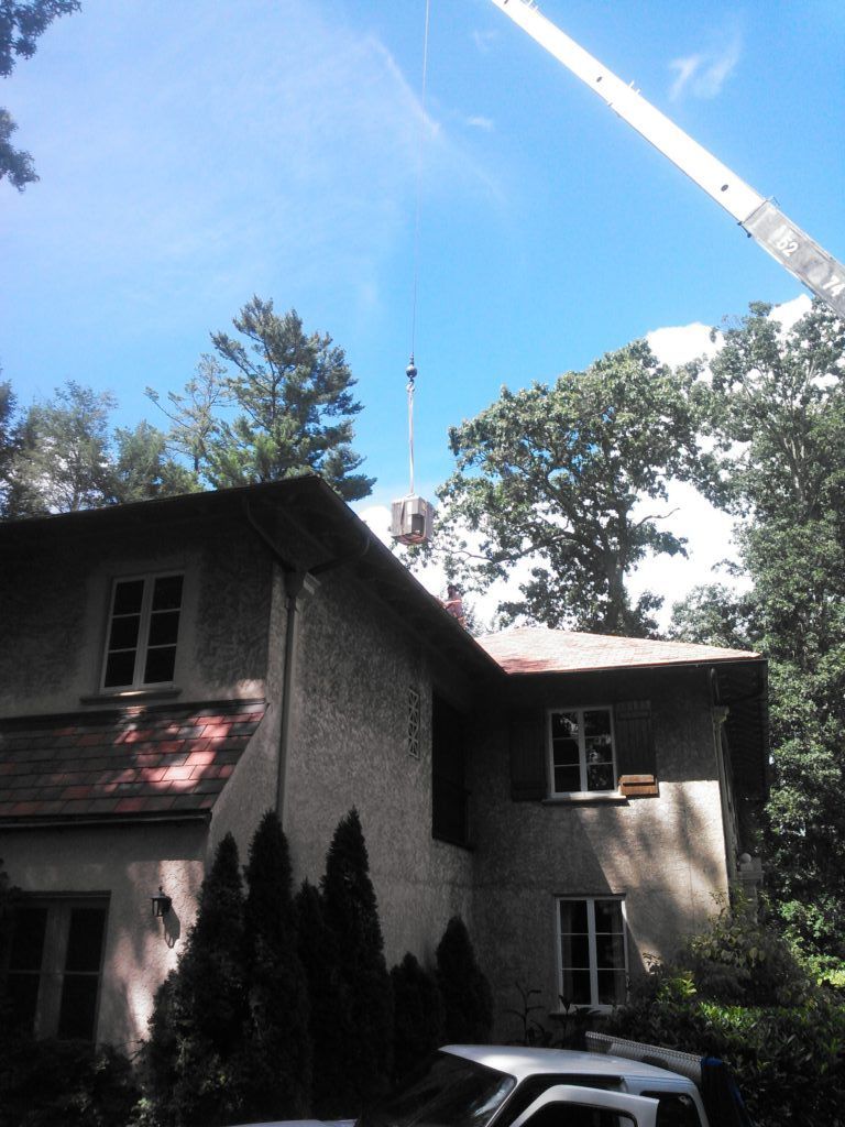 A white truck is parked in front of a large house