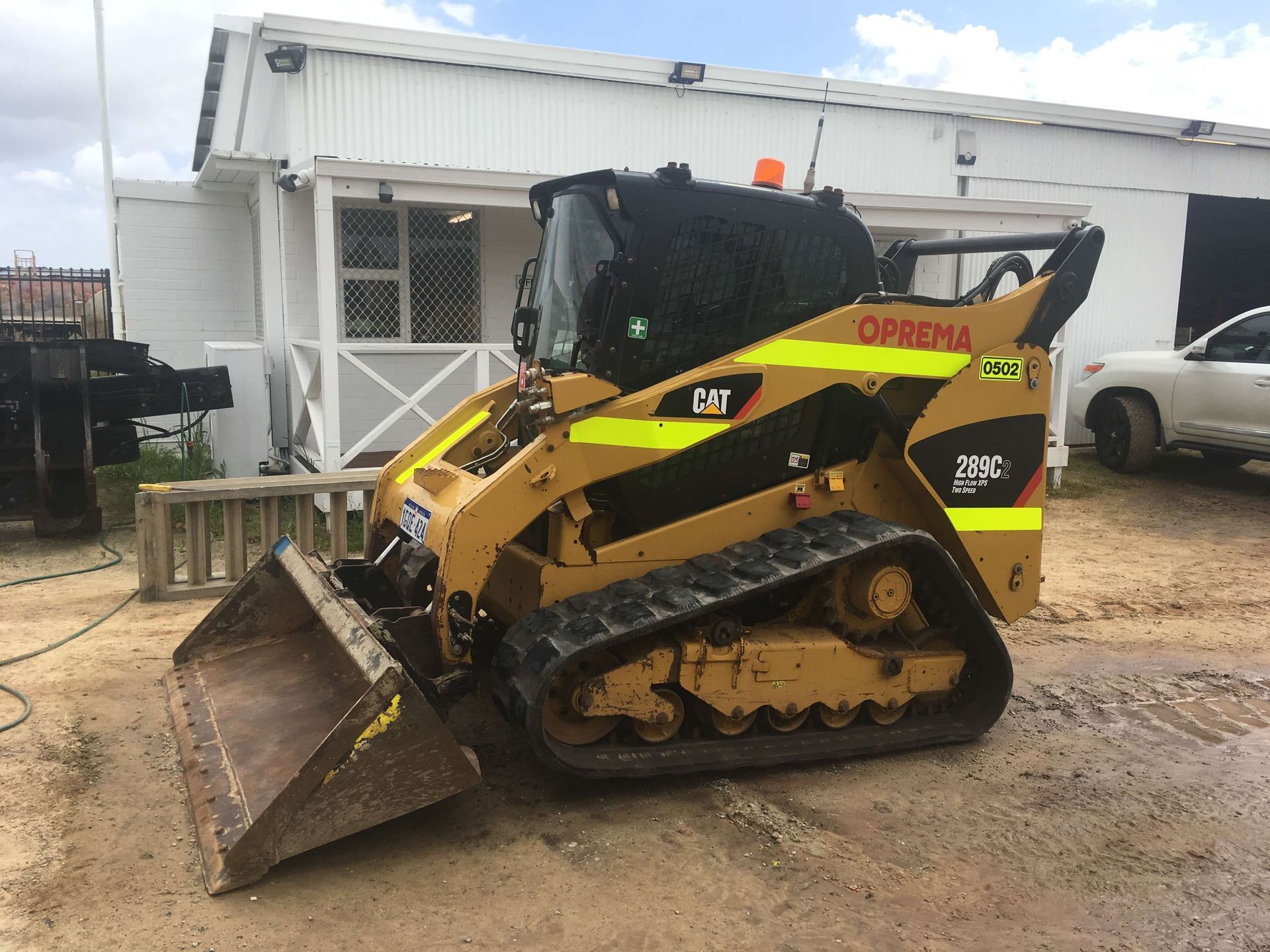 A bulldozer is parked in front of a building.