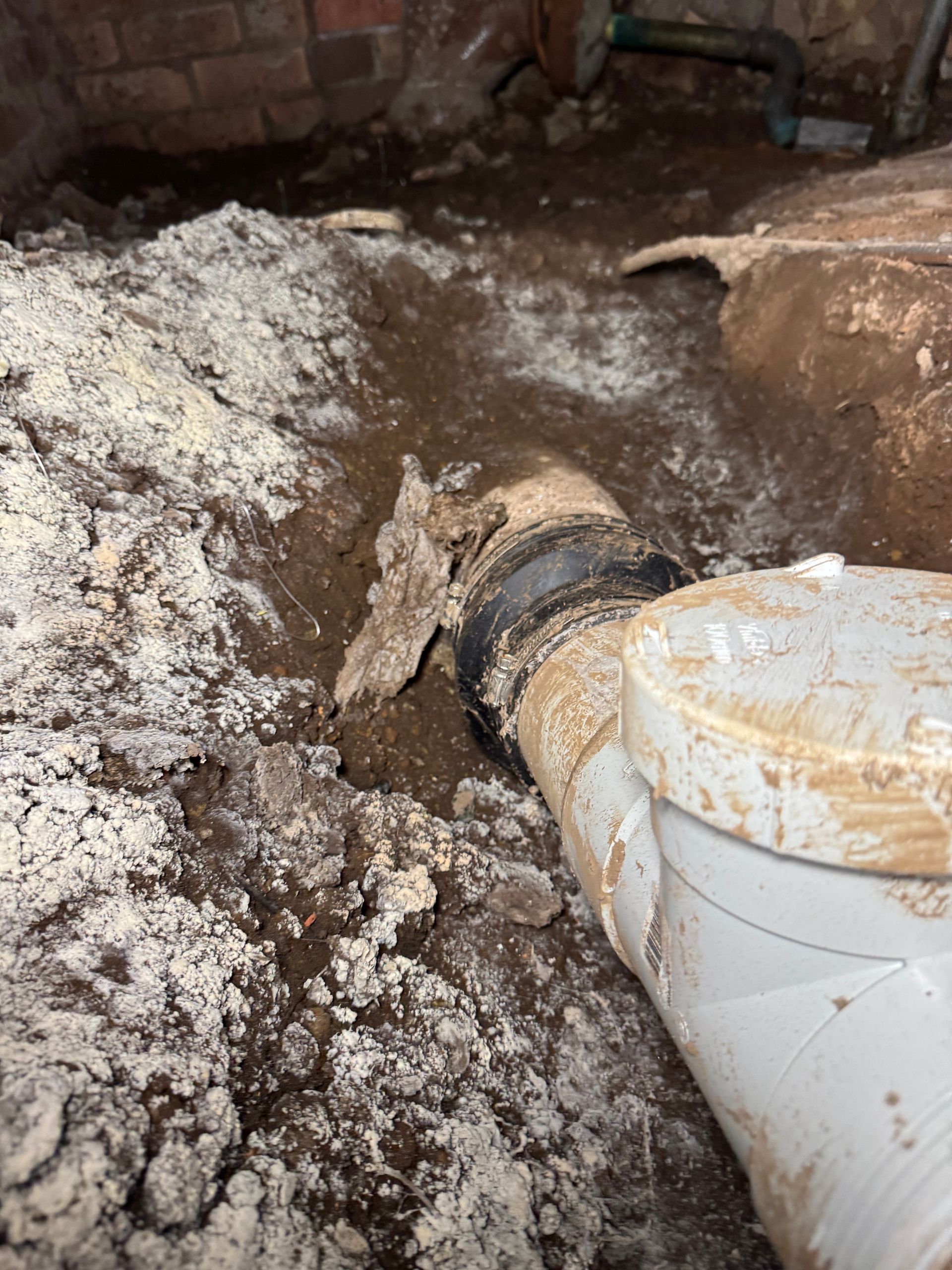 Basement with white powdery substance, exposed plumbing, and dirt — Fair Plumbing In Shellharbour, NSW