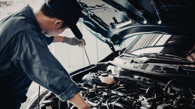 a mechanic doing routine maintenance on a vehicle