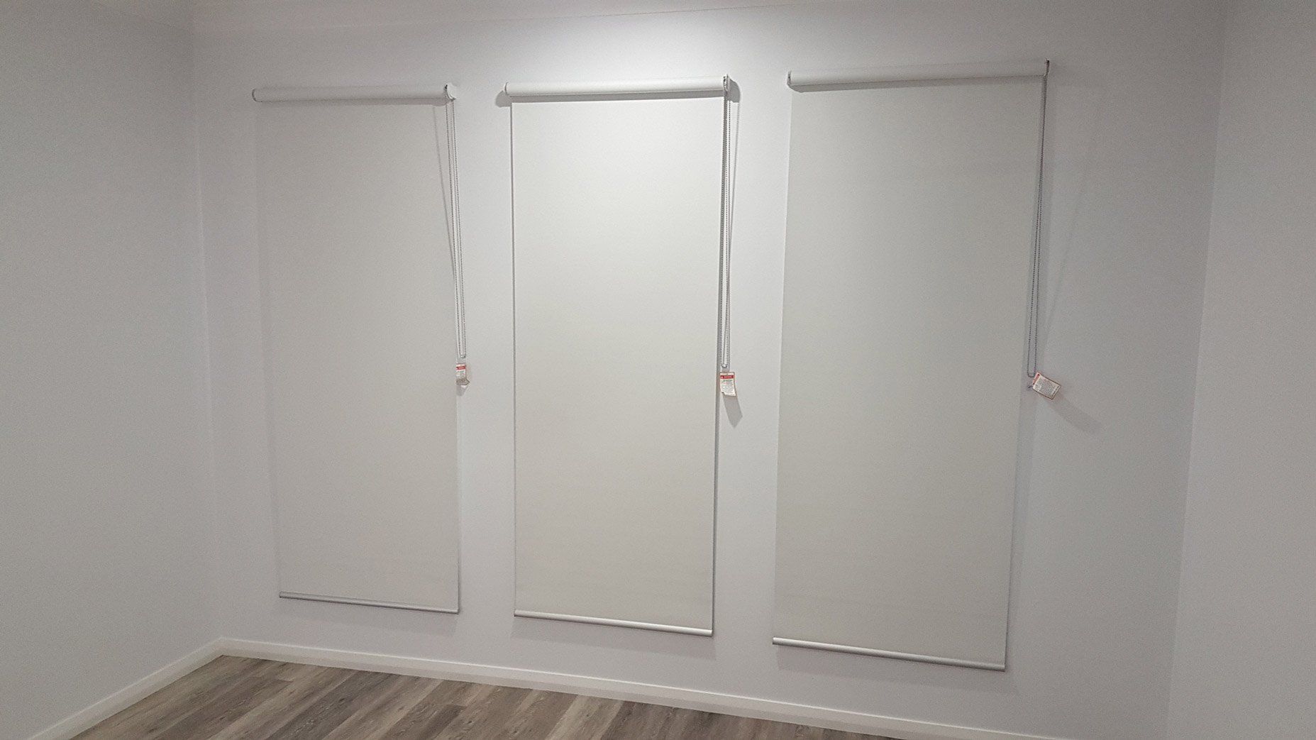 Three Windows With Rolled Down Blinds — Blinds Installation in Winnellie, NT