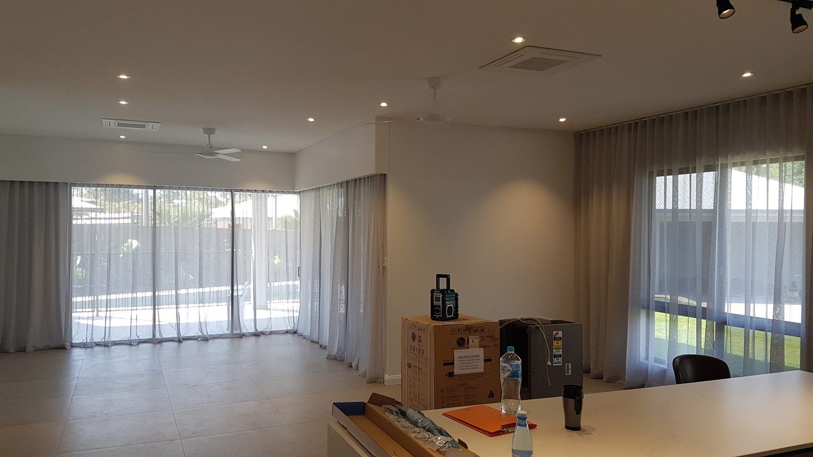 Spacious Room With Table And Box — Blinds Installation in Winnellie, NT