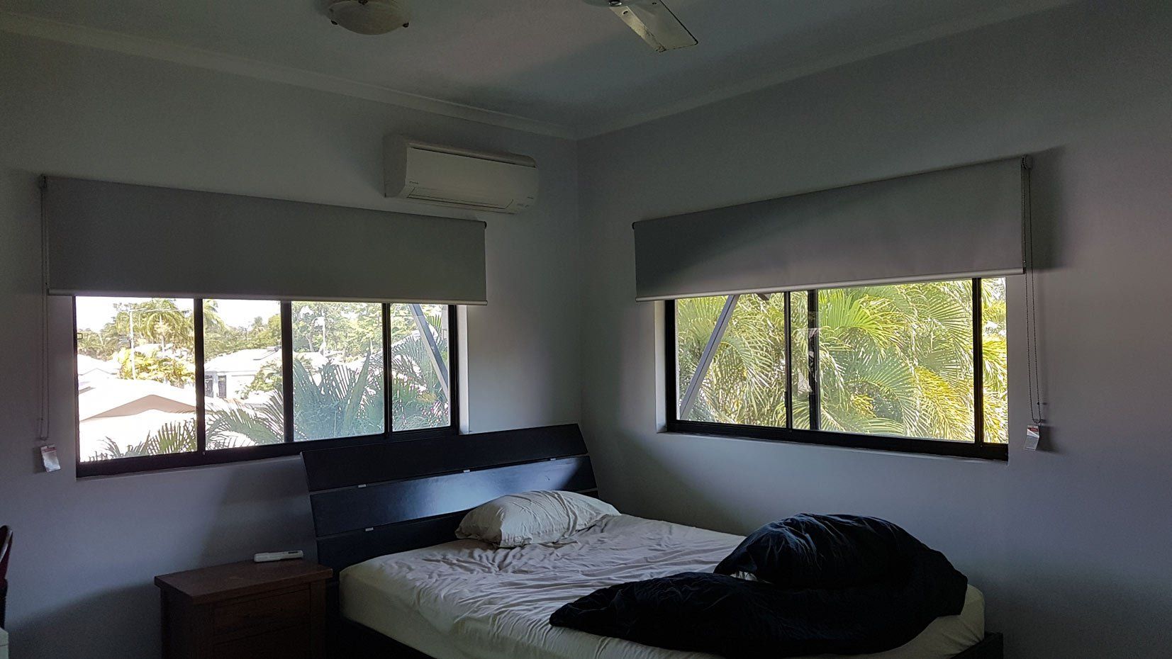 Bedroom With Two Sunscreen Roller Blinds — Blinds Installation in Winnellie, NT