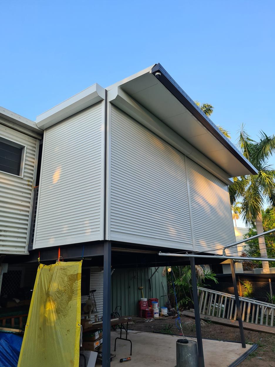 Roller Shutters In A Residential House — Blinds Installation in Winnellie, NT