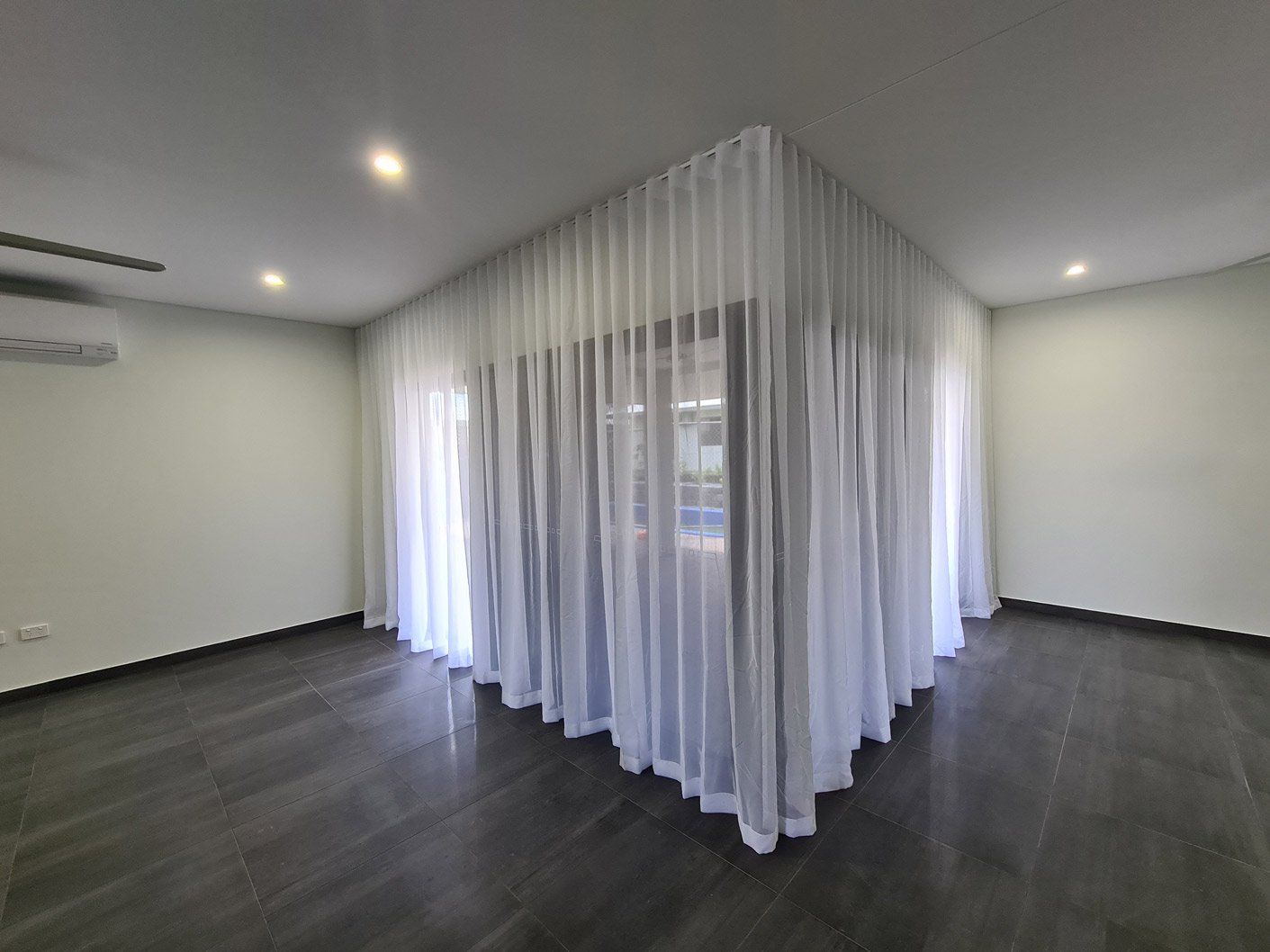 Room With White Mesh Curtains — Blinds Installation in Winnellie, NT