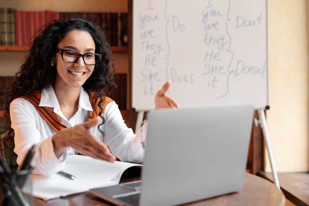 A Woman is Sitting at a Desk in Front of a Laptop Computer — Successful Resumes in Townsville, QLD