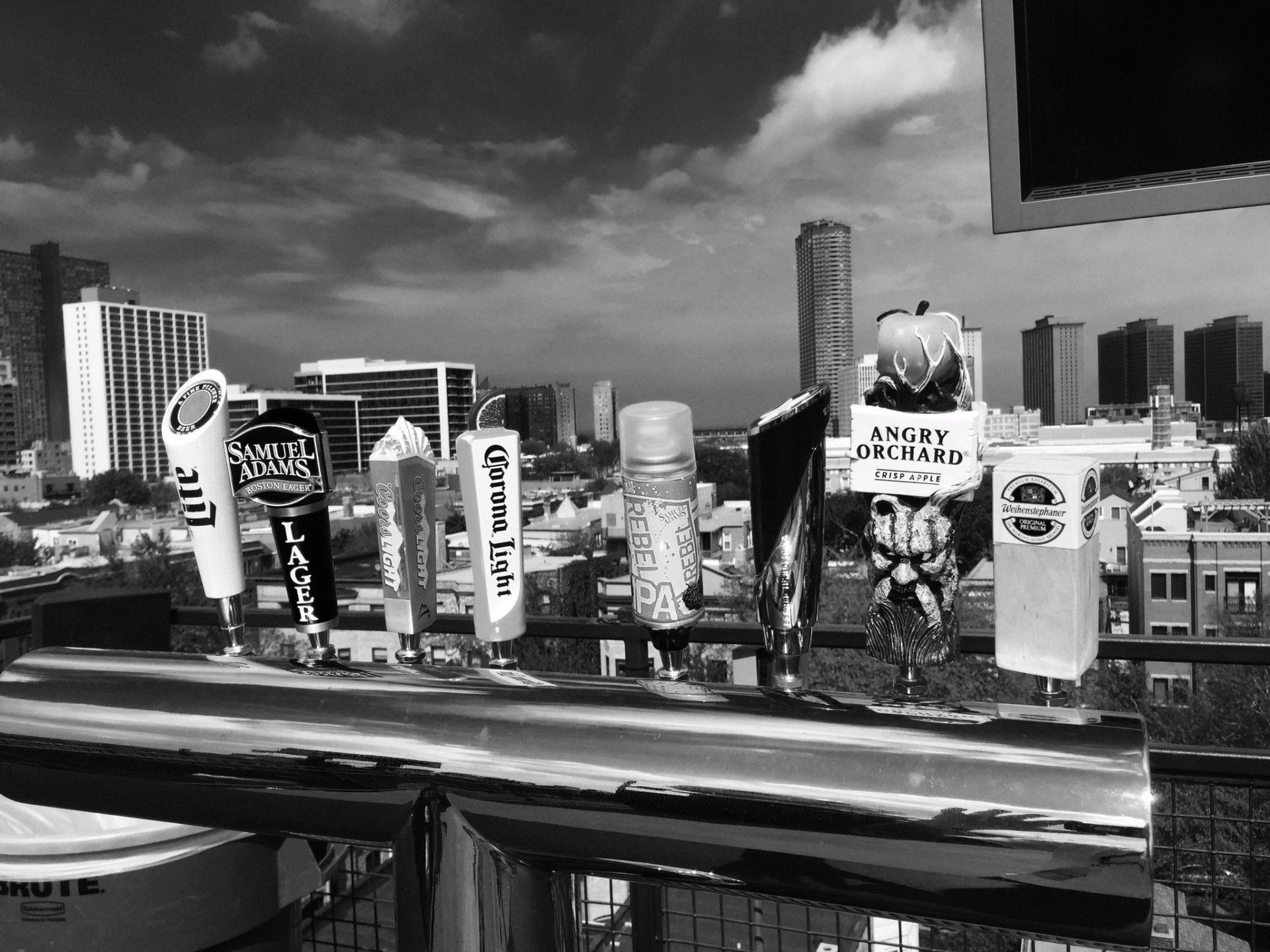 A black and white photo of a city with a lot of beer taps