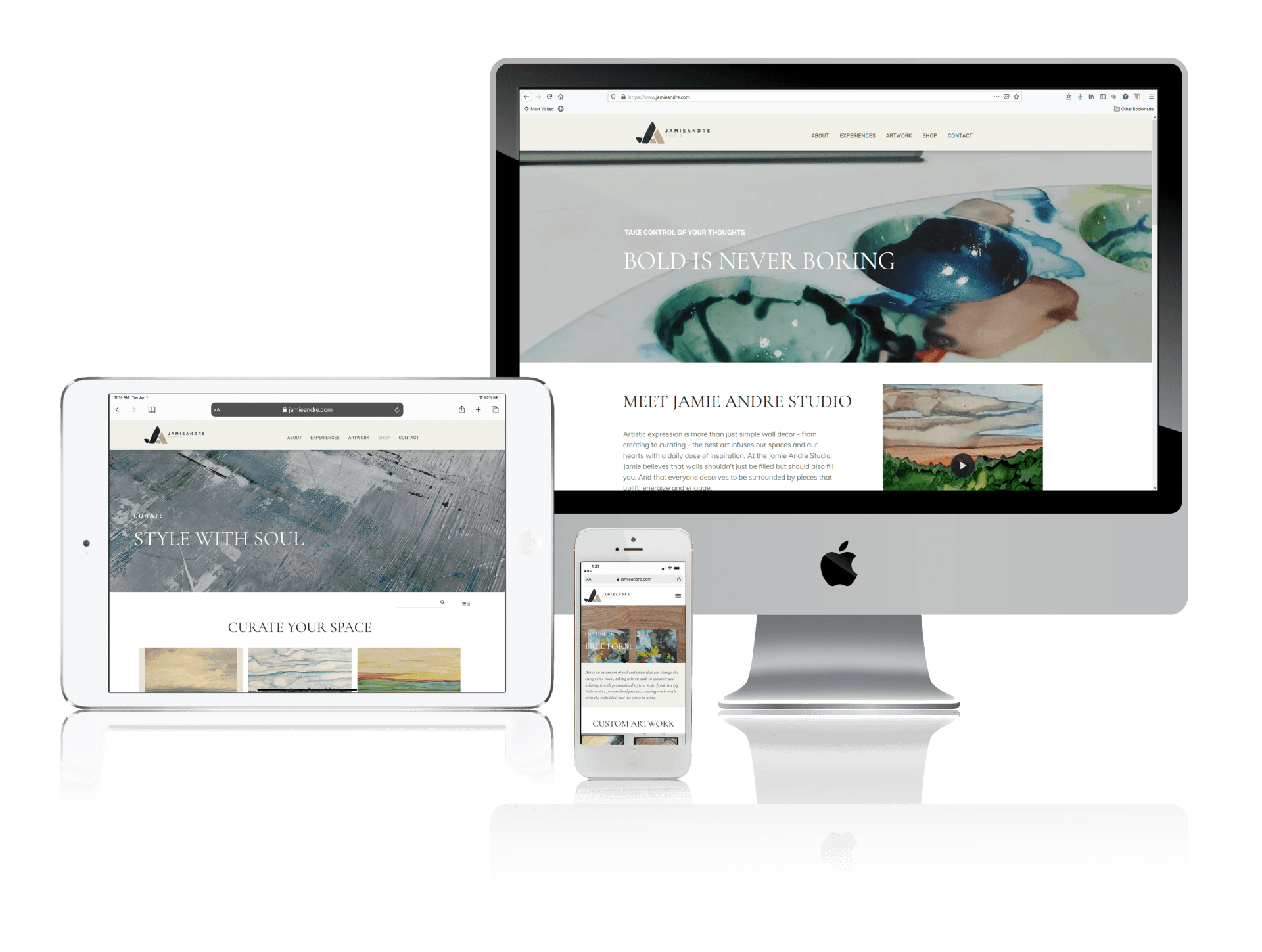 A computer , tablet , and cell phone are sitting next to each other on a table.