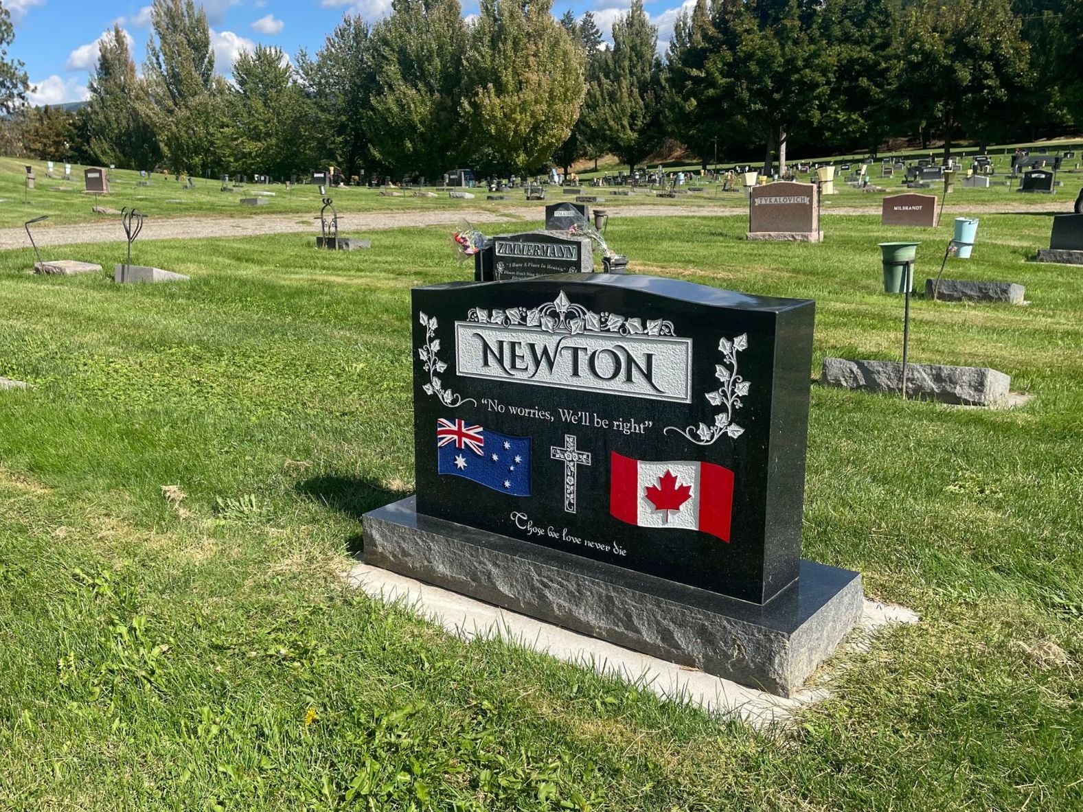 A gravestone for newton is in a cemetery.