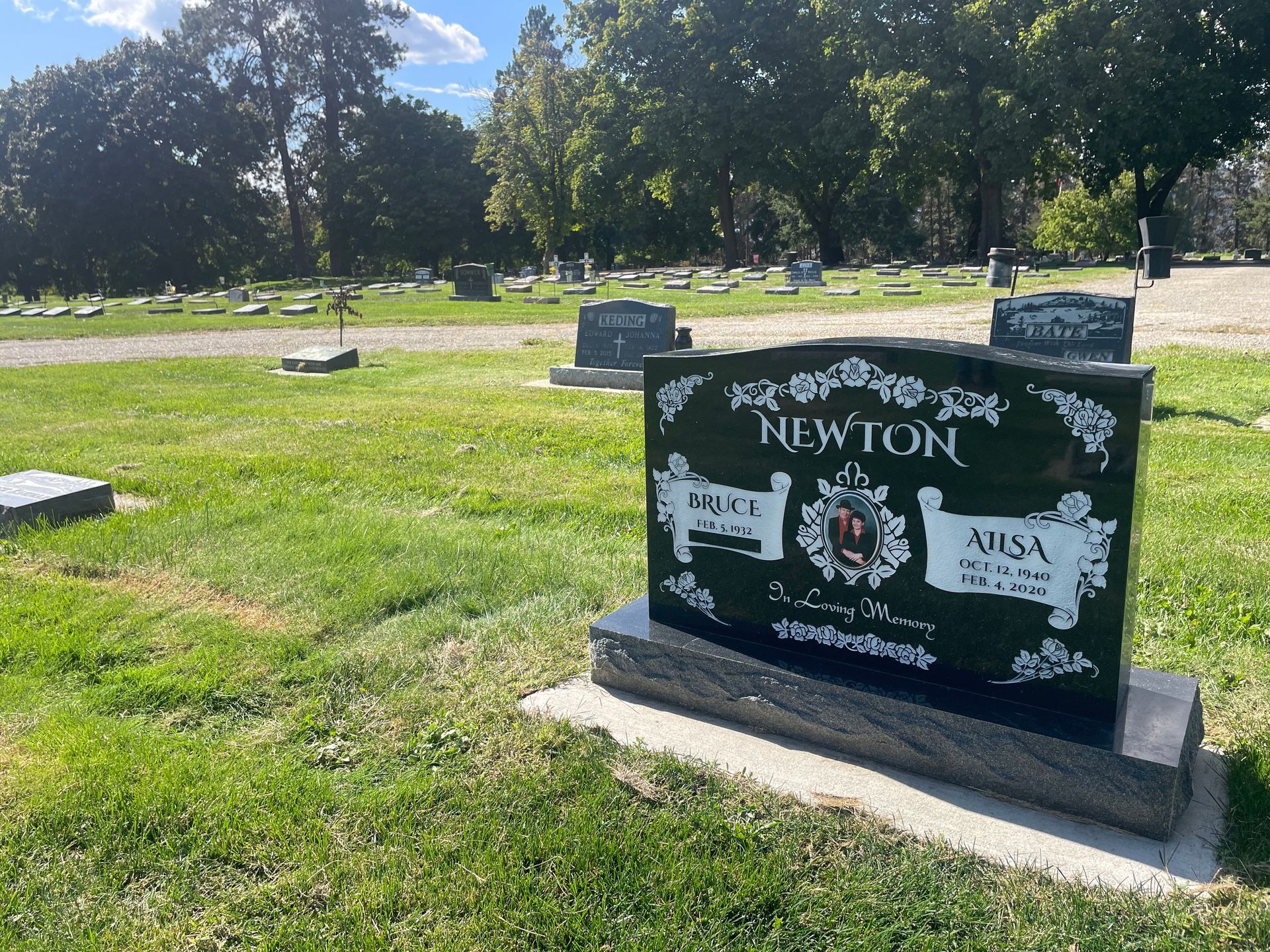 A gravestone in a cemetery with the name newton on it.