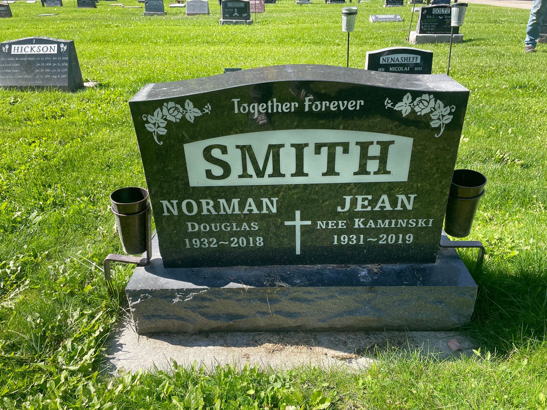 The grave of norman and jean smith in a cemetery