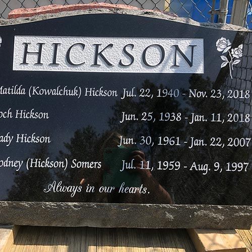 A black gravestone with the name hickson on it