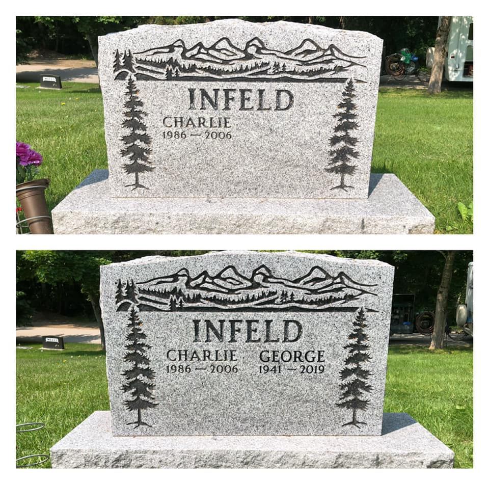 A couple of gravestones with trees and mountains on them in a cemetery.