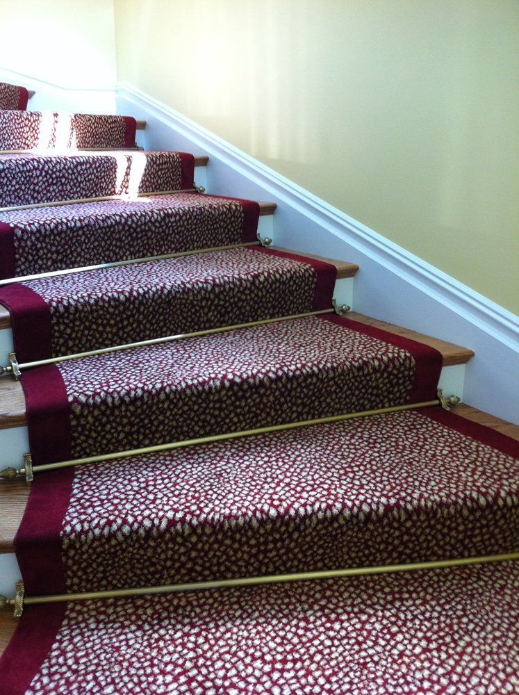 A set of stairs with a red carpet on them