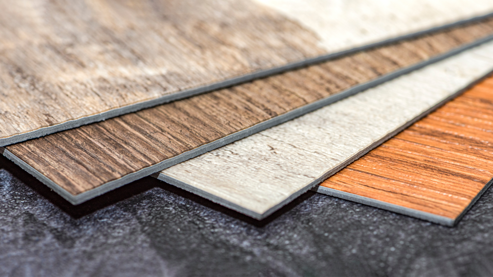 A wooden floor is being installed on a concrete floor.