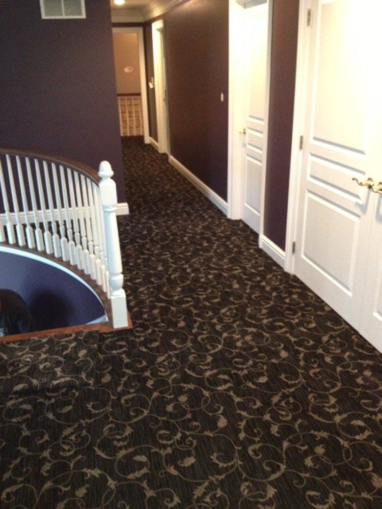 A hallway with a staircase in the middle of it