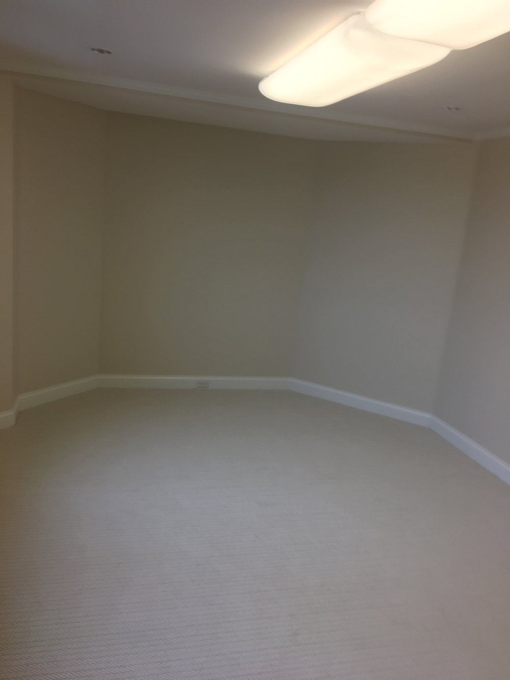 An empty room with a light on the ceiling