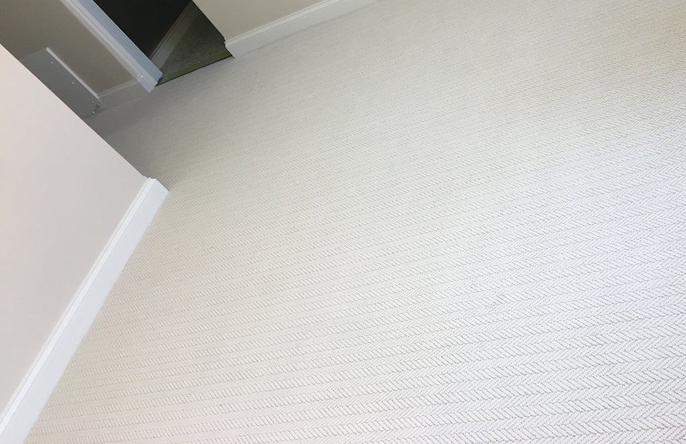 A close up of a white carpet in a room