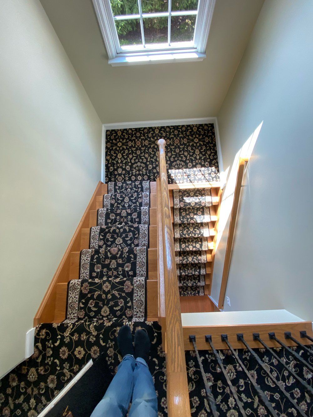 A person is sitting on the stairs with their legs crossed