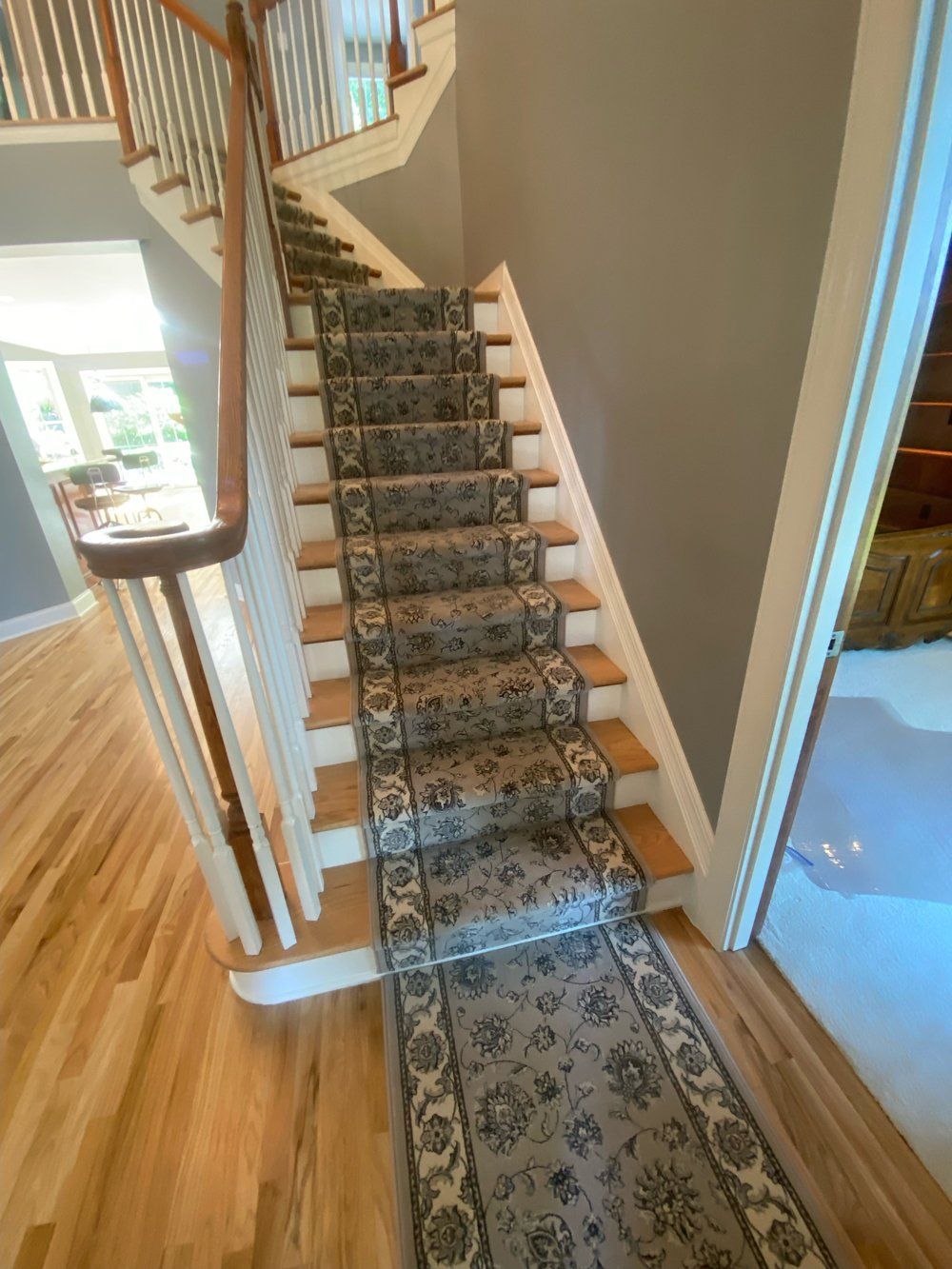 A staircase with a floral carpet on the steps