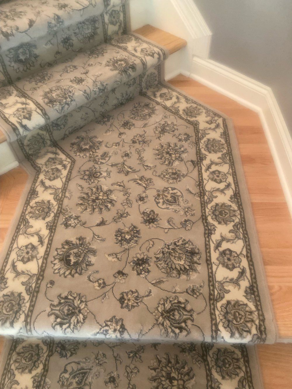 A carpeted staircase with a floral pattern on it
