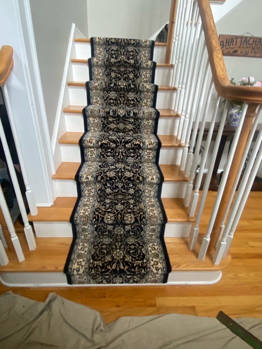 A staircase with a black carpet on it