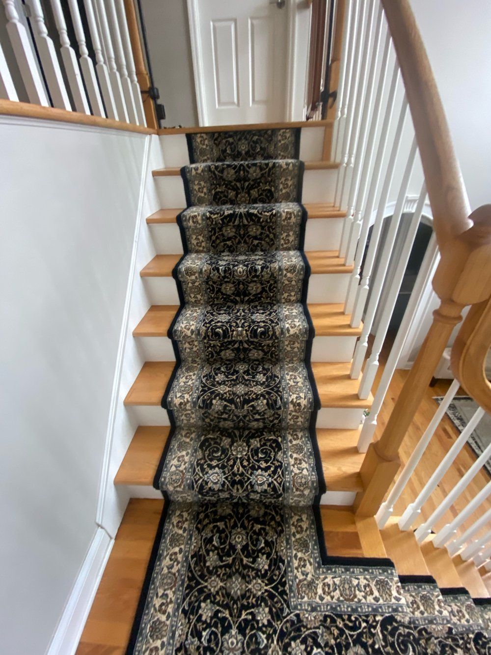 A staircase with a black carpet on the steps