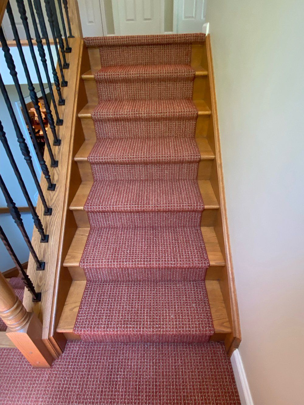 A wooden staircase with a red carpet on it