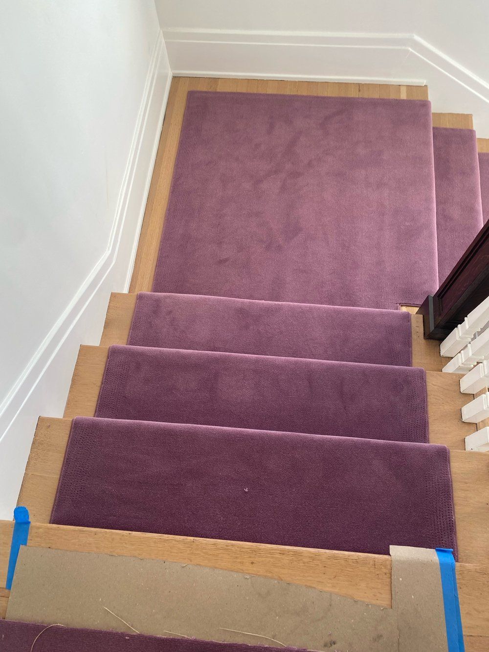 A set of stairs with purple carpet on them