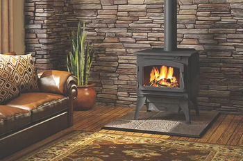 A living room with a wood stove and a couch