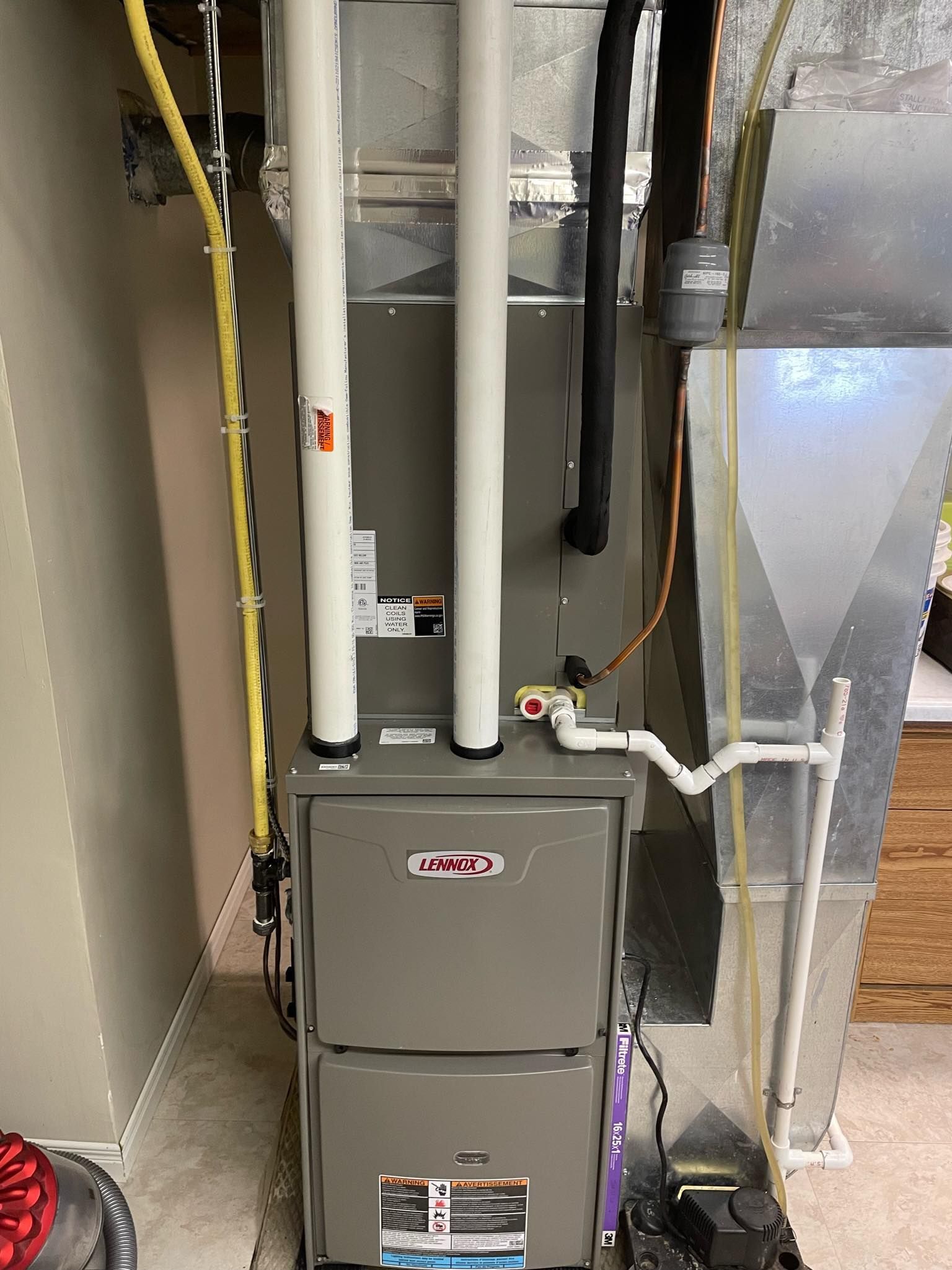 A heating and cooling system is installed in a basement.
