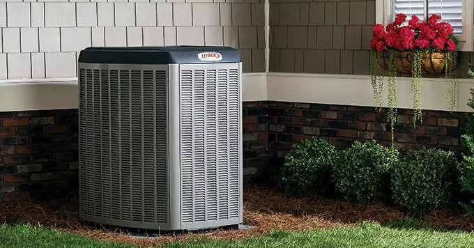 An air conditioner is sitting on the side of a house