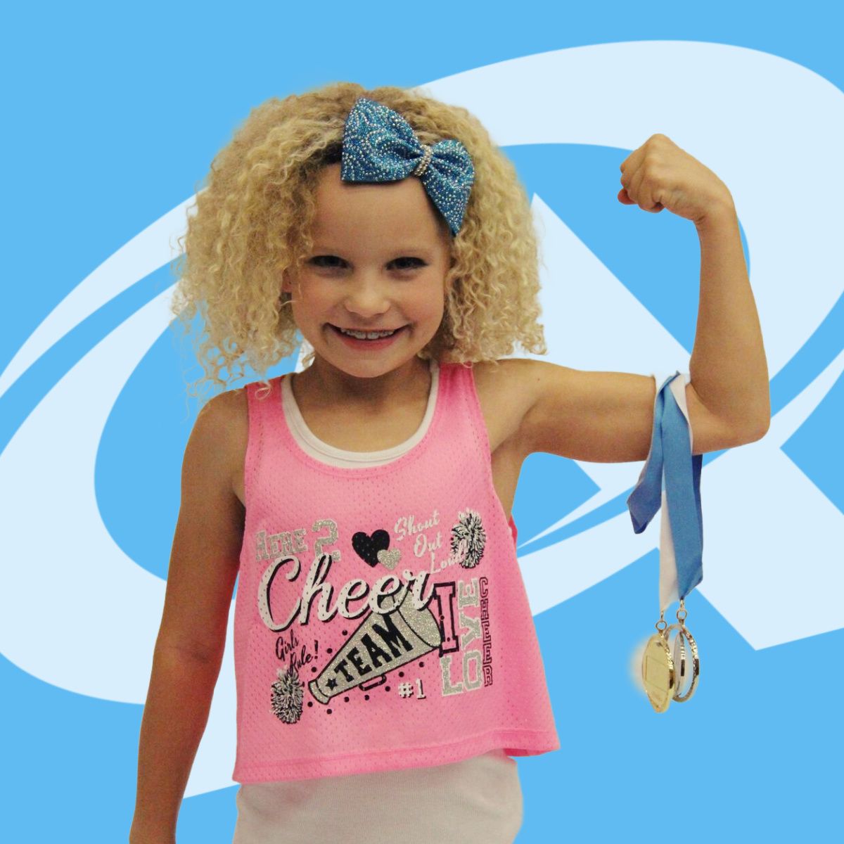 A little girl wearing a pink tank top that says cheer