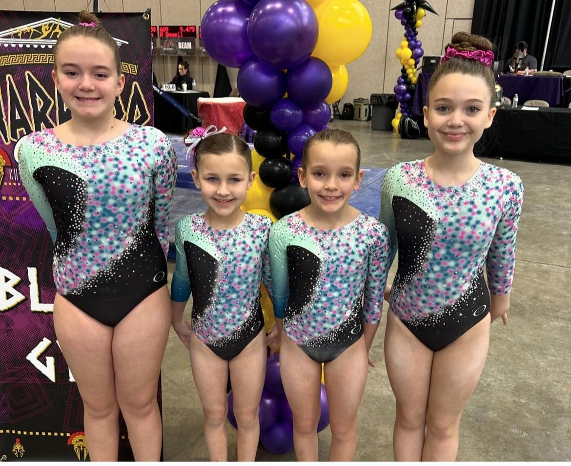 girls in leotards smiling