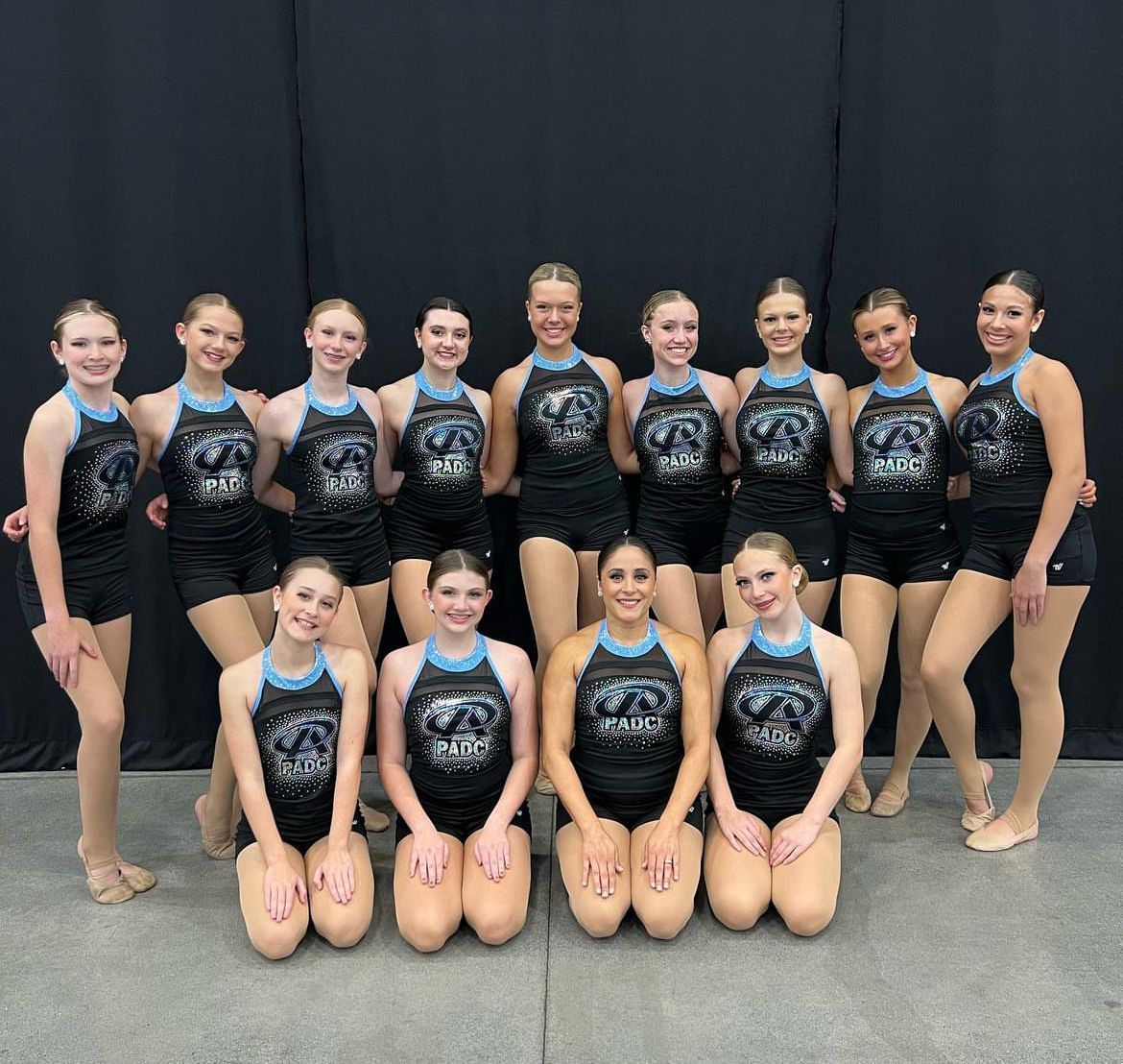 A group of young women are posing for a picture together.