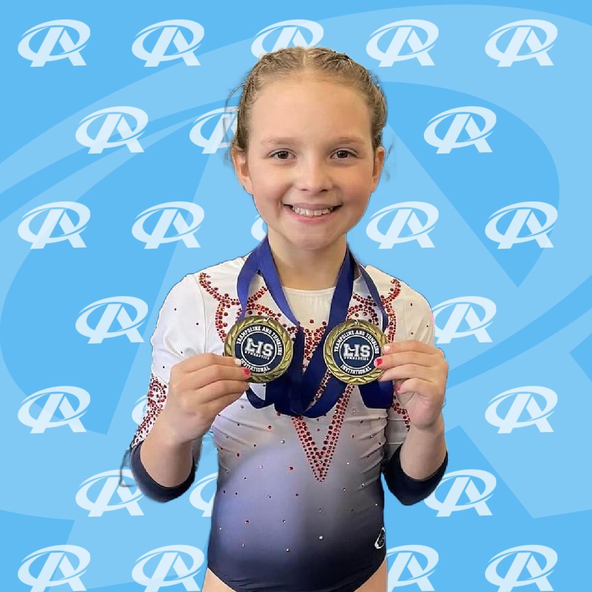 A young girl in a leotard is holding two medals and smiling