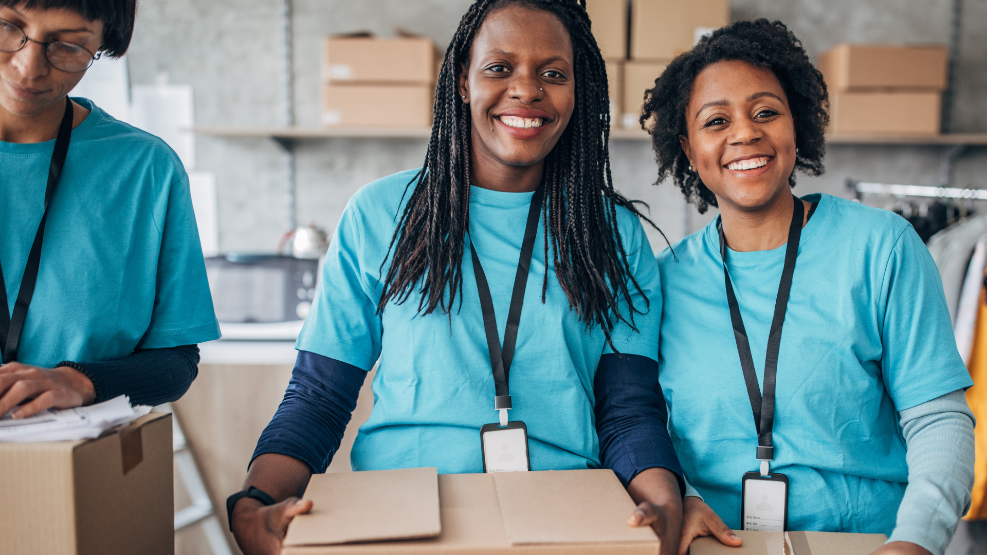 Volunteers packing donated items into boxes at a community distribution center