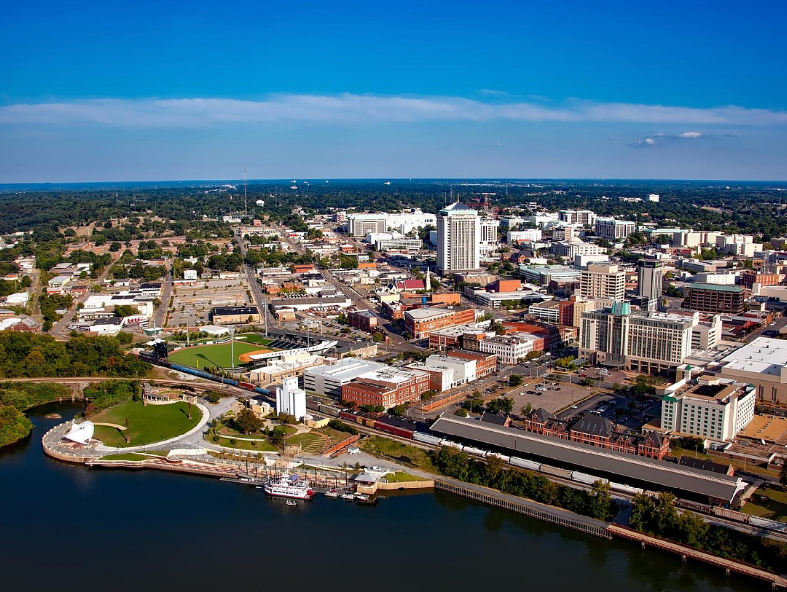 Mid-century modern credenza with a lamp and decorative objects, in a sunlit room.