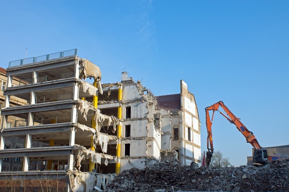 A Large Building Is Being Demolished by A Bulldozer — Albury Demolitions in Lavington, NSW