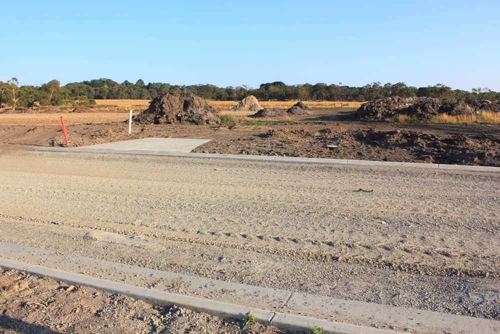 A Dirt Road Going Through a Field with Trees in The Background — Albury Demolitions in Yarrawonga, NSW