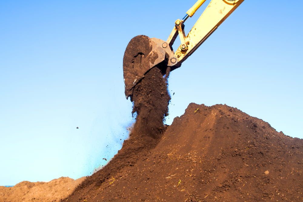 A Large Pile of Dirt Is Being Scooped up By an Excavator — Albury Demolitions in Lavington, NSW