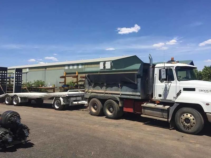 A Dump Truck with A Trailer Attached to It Is Parked in A Parking Lot — Albury Demolitions in Yarrawonga, NSW
