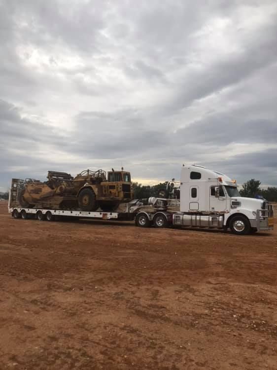 A Semi Truck Is Carrying a Bulldozer on A Trailer — Albury Demolitions in Lavington, NSW