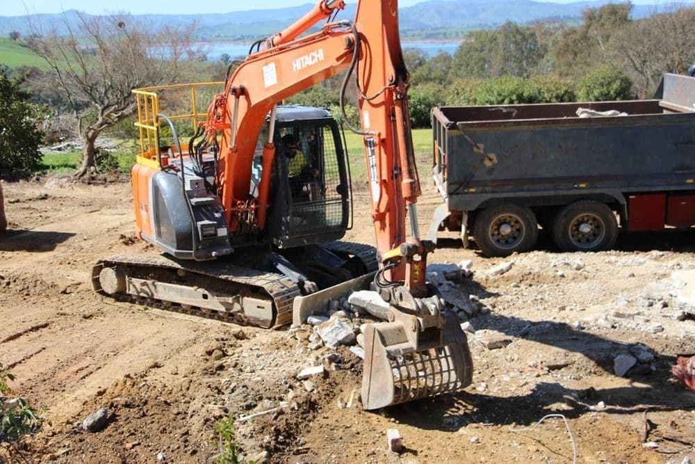 A Bulldozer Is Moving Dirt on A Construction Site — Albury Demolitions in Yarrawonga, NSW
